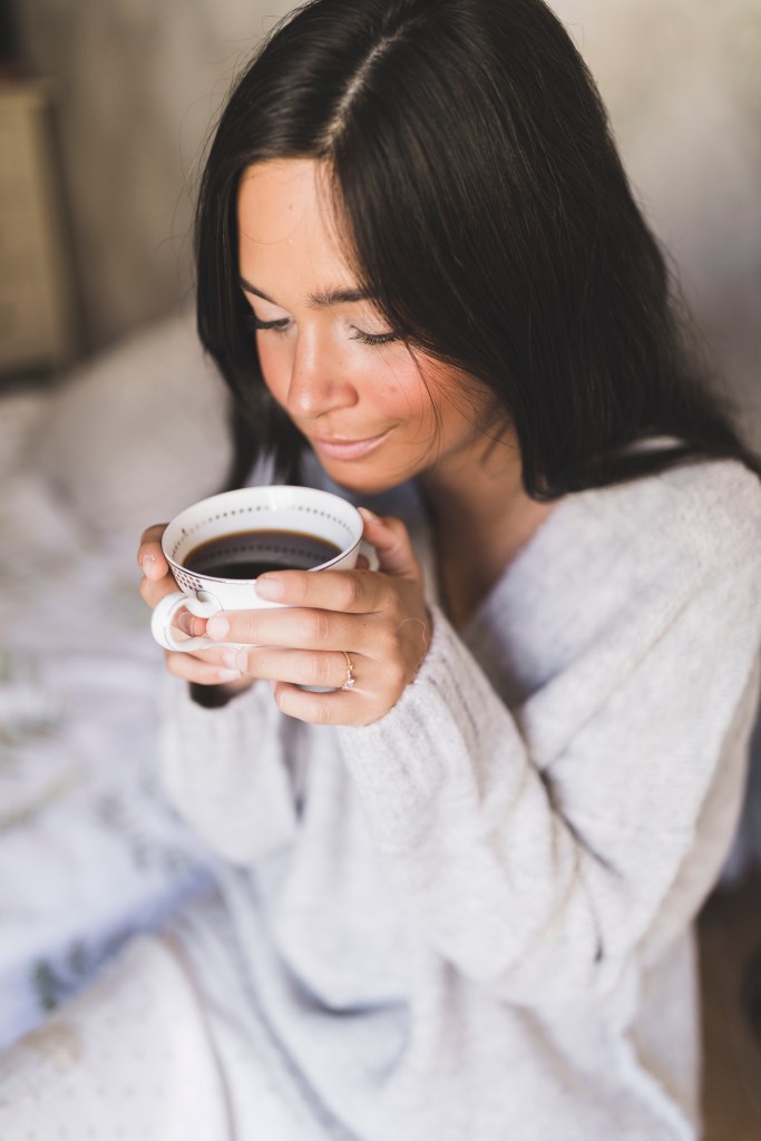woman enjoying her breville espresso maker coffee at home